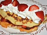 Gluten free crepes stuffed with strawberries, jam & whipped cream