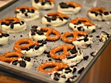 Pretzels dipped in white chocolate & topped with crushed oreos