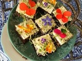 Pumpernickel sandwiches with herb cream cheese and edible flowers