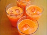 Refreshing orange and carrot juice, garden produce and flops