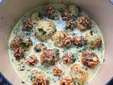 Zucchini and ricotta dumplings in spinach and blue cheese cream, with walnuts