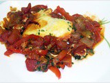 Eggs in a skillet with spicy tomato and bell pepper sauce Ellie Krieger