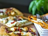 Pesto pizza with chicken, mozzarella, and sun-dried tomatoes