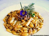 Gnocchetti sardi risottati, con crema di carciofi, calamari e polvere di caffè