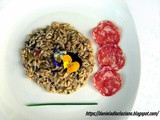 Risotto alle erbe primaverili , fiori eduli e salame piacentino Dop