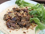 Za’atar aubergines and toasted pine nuts on silky hummus