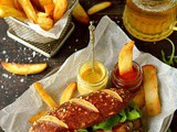 Sausages With Beer Pretzel Buns, Beer Braised Onions & Roasted Garlic Butter