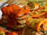 Basa Fish Fillet served in a bed of grilled zucchini and topped with red creamy sauce, some steamed veggies and garlic roasted bread