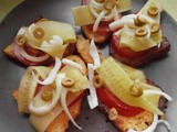 Fried bread with parmesan, cucumber, tomato, onion and olives