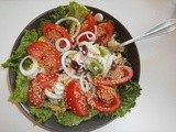 Rice salad with tomatoes, corn, pineapple, kidney beans and sesame seeds