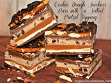Cookie dough snickers bars with a salted pretzel topping