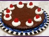 Flourless chocolate cake with fresh whipped cream & raspberries