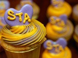 Vanilla cupcakes with buttercream frosting and homemade royal icing candy toppers