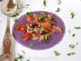 Ciuffetti di calamaro con capperi, olive di Gaeta e ciliegini semisecchi su crema di patate viola