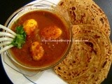 Egg curry in tamarind sauce and wheat lacha paratha
