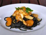 Spaghetti al nero di seppia con baccalà e pomodorini gialli