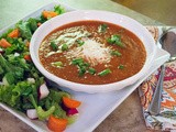 Creamy Tomato Soup with Cherry Tomatoes and Salty Parmesan Cheese