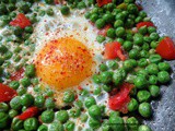 Eggs with peas and tomatoes, flavored with cumin and chili flakes