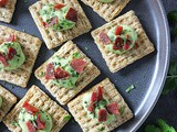 Avocado Crema And Bacon topped triscuit Crackers