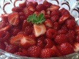 Compote of summer berries with scented geranium leaves