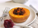 Vegan stuffed butternut squash with cranberry and juniper sauce